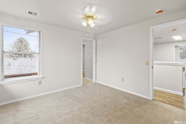 carpeted empty room with ceiling fan