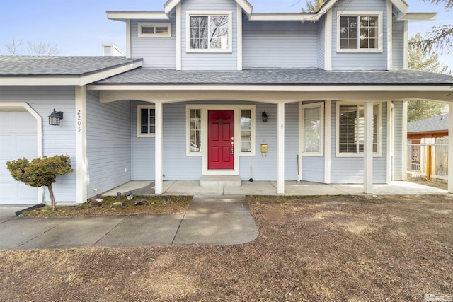 view of front facade featuring a garage and covered porch