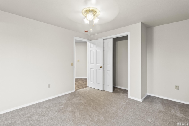 unfurnished bedroom featuring a closet, ceiling fan, and carpet flooring