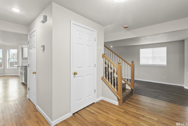 corridor with hardwood / wood-style floors