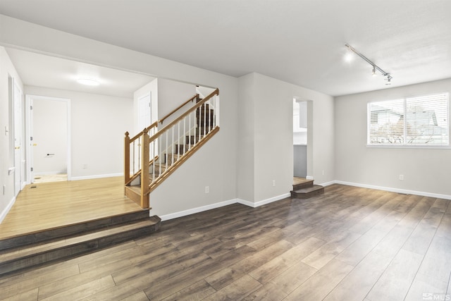 interior space with hardwood / wood-style flooring and track lighting