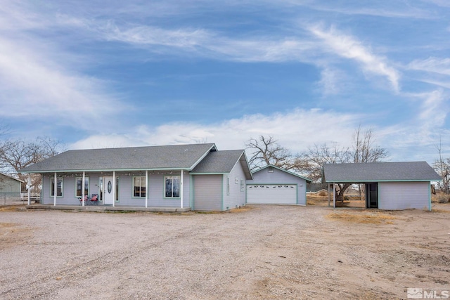 ranch-style house featuring a carport and covered porch