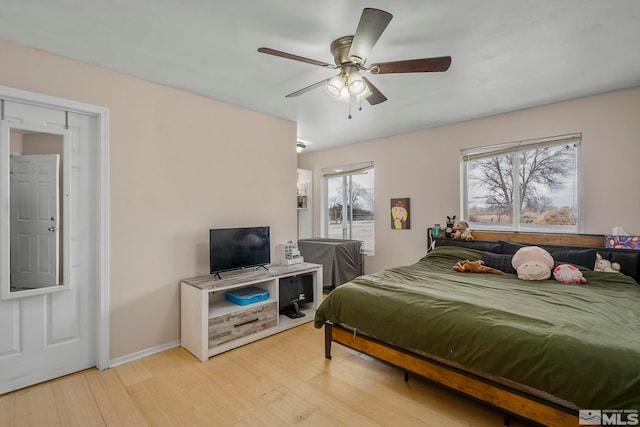 bedroom with ceiling fan and light hardwood / wood-style floors