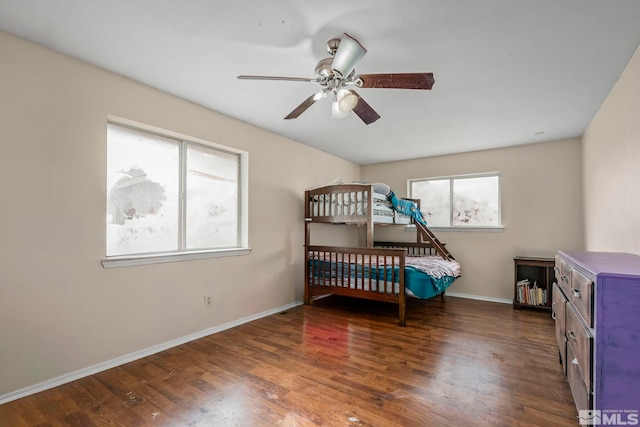 bedroom with ceiling fan and dark hardwood / wood-style flooring