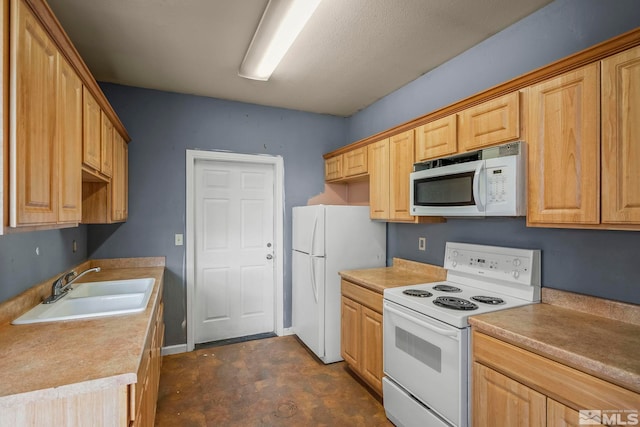 kitchen featuring sink and white appliances