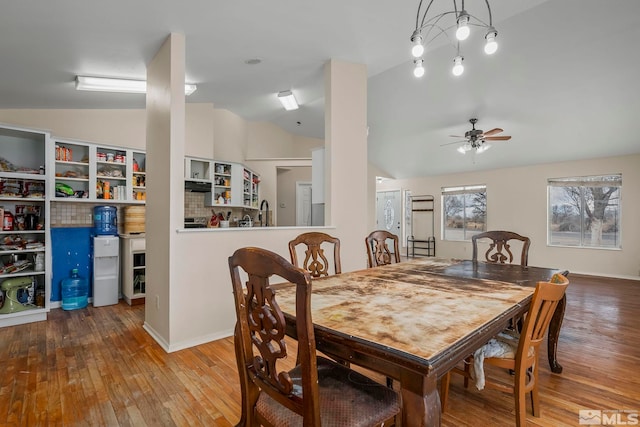 dining room with ceiling fan, lofted ceiling, and hardwood / wood-style floors