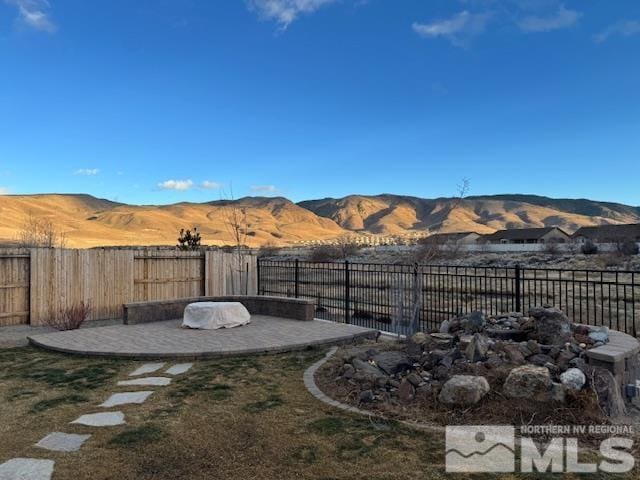 view of yard featuring a mountain view and a patio