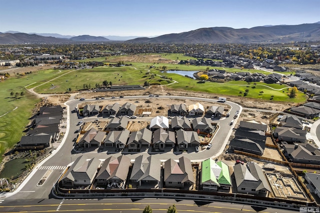 aerial view with a residential view, golf course view, and a water and mountain view