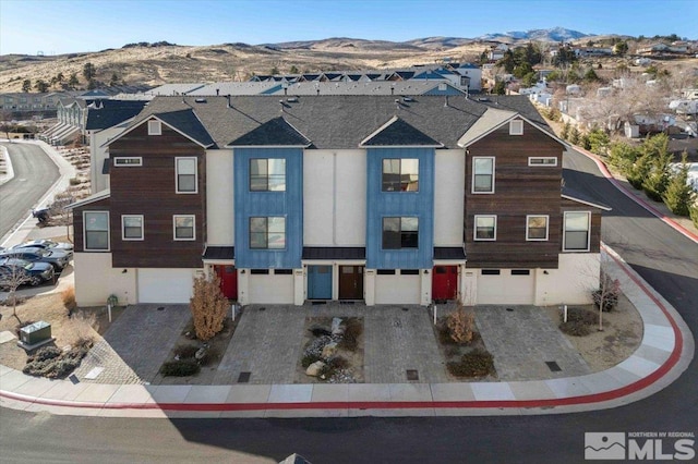 view of front of house featuring a mountain view and a garage