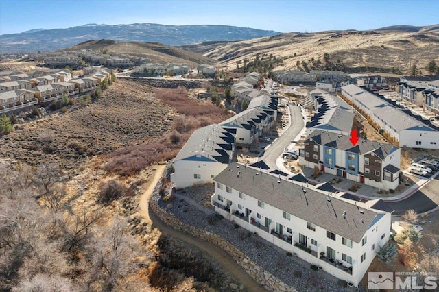 birds eye view of property featuring a mountain view