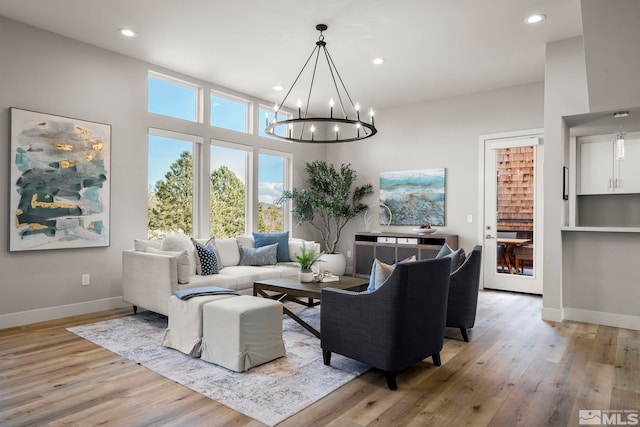 living room featuring light hardwood / wood-style flooring and a notable chandelier