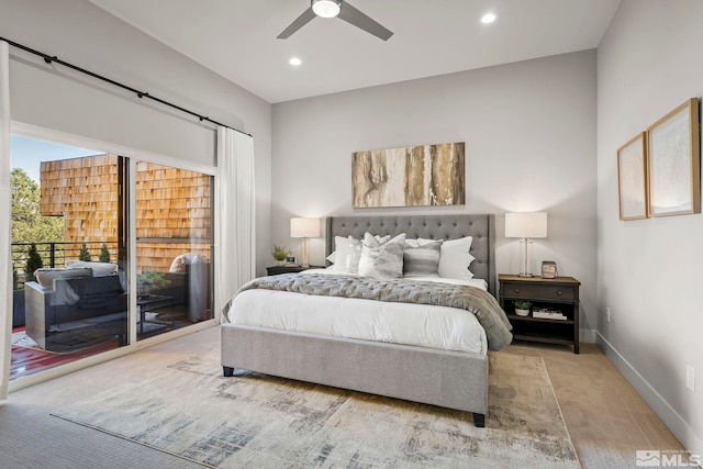 bedroom with a barn door, access to outside, light colored carpet, and ceiling fan