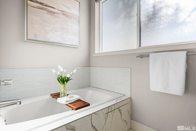 bathroom with tiled bath