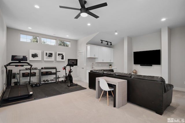 exercise area with ceiling fan, track lighting, light carpet, and indoor wet bar