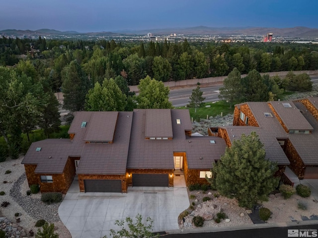 aerial view at dusk featuring a mountain view