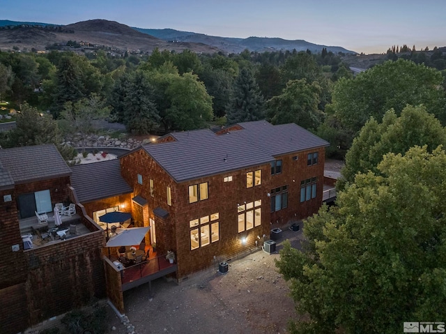 aerial view at dusk featuring a mountain view