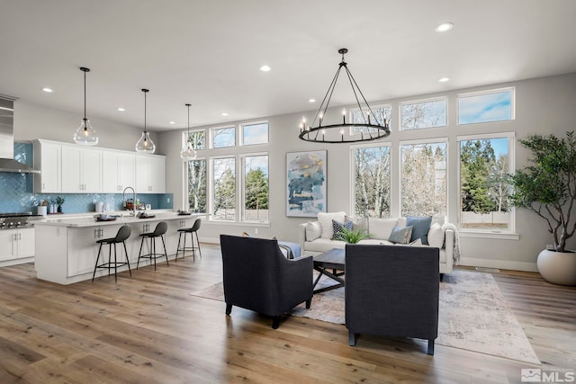 dining space with light hardwood / wood-style floors and a notable chandelier