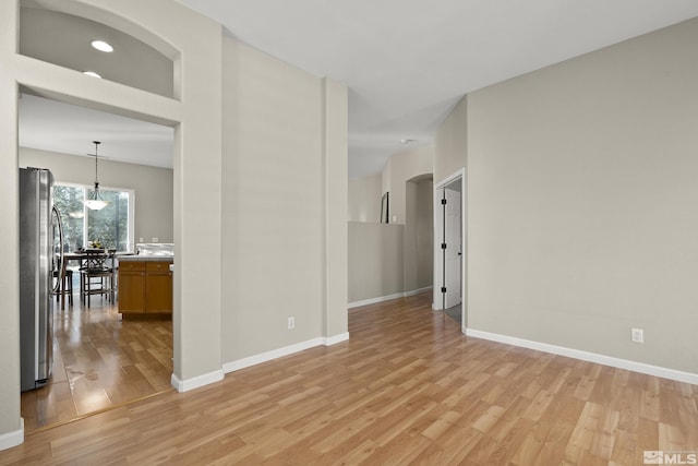 spare room featuring light wood-type flooring