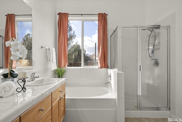 bathroom with vanity and separate shower and tub