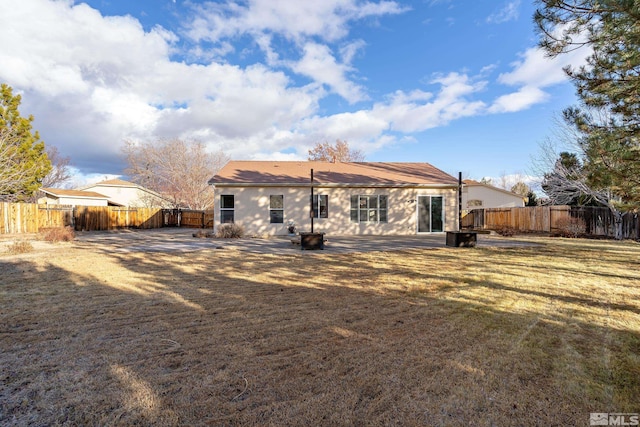 back of house with a lawn