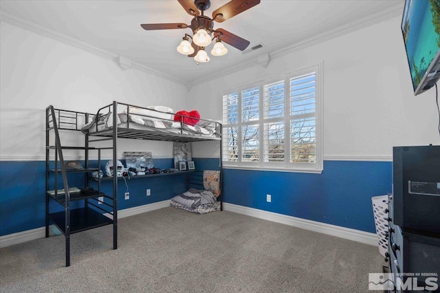 carpeted bedroom featuring crown molding and ceiling fan