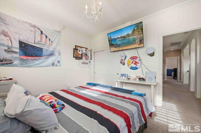 carpeted bedroom with crown molding and a notable chandelier