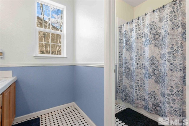 bathroom with tile patterned flooring, vanity, and a shower with curtain