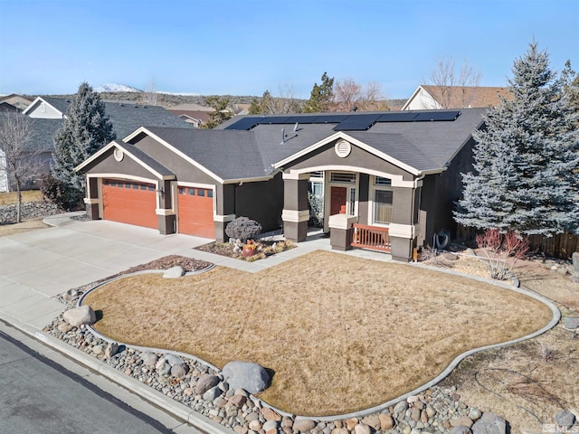 single story home featuring a garage, covered porch, and solar panels