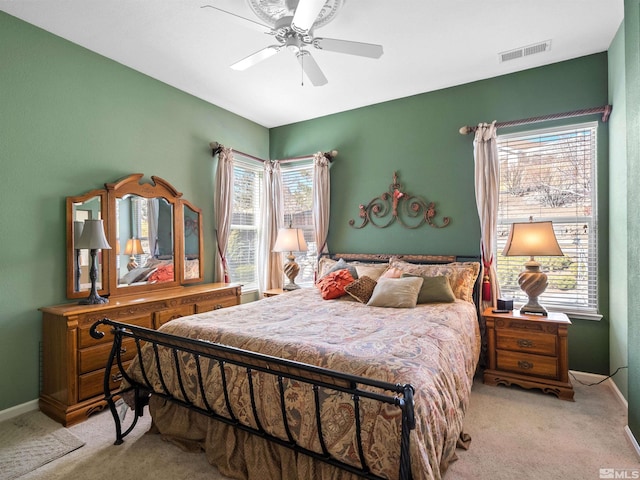 bedroom with ceiling fan and light colored carpet