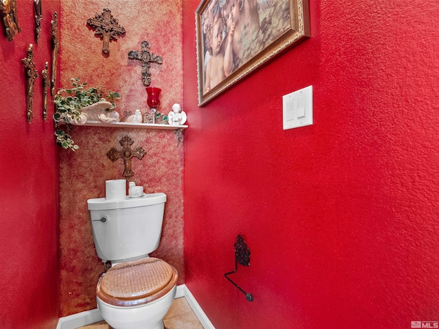 bathroom featuring toilet and tile patterned flooring