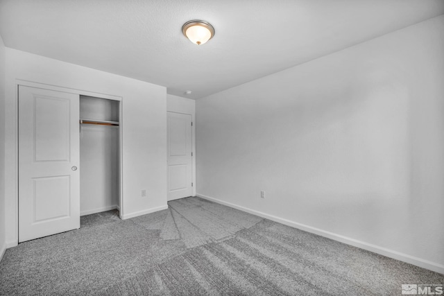 unfurnished bedroom featuring carpet floors and a closet