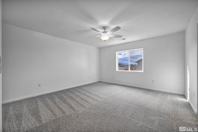 spare room featuring ceiling fan and carpet flooring