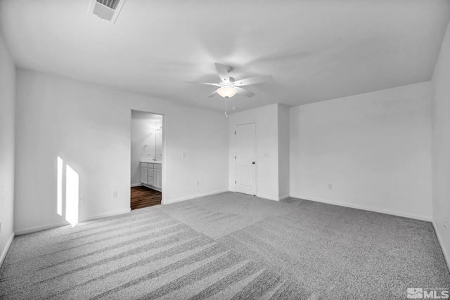 carpeted spare room featuring ceiling fan