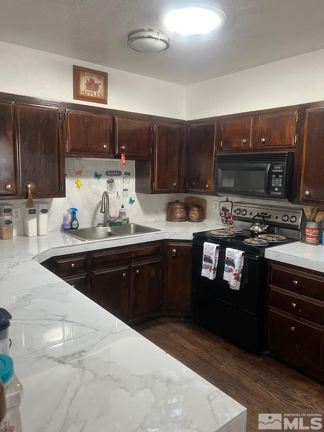 kitchen featuring dark wood-type flooring, dark brown cabinetry, sink, and black appliances