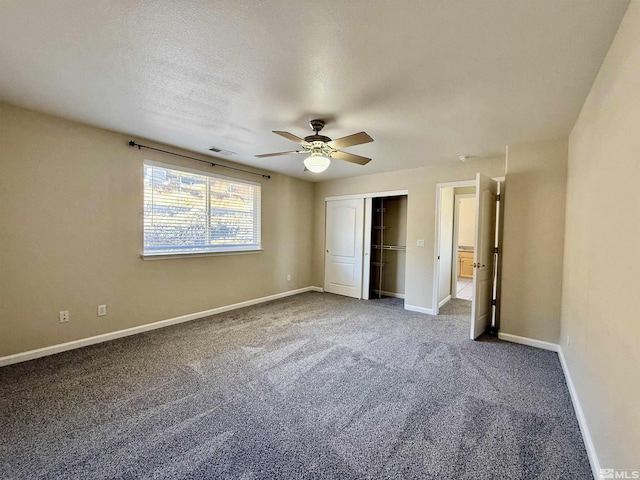 unfurnished bedroom featuring ceiling fan, carpet floors, a closet, and a textured ceiling