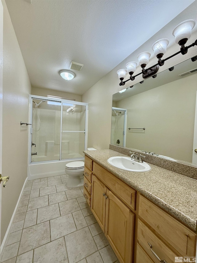 full bathroom with vanity, a textured ceiling, shower / bath combination with glass door, and toilet