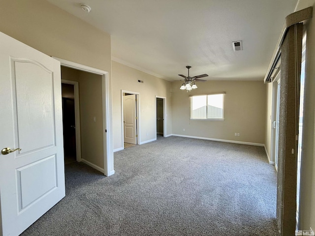 unfurnished bedroom featuring dark colored carpet and ceiling fan