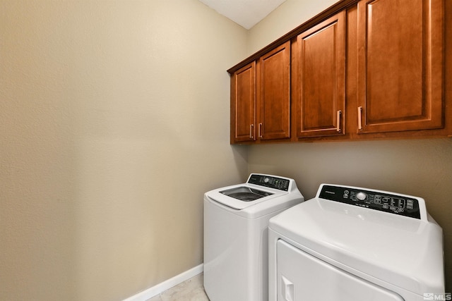 laundry area with washer and dryer and cabinets