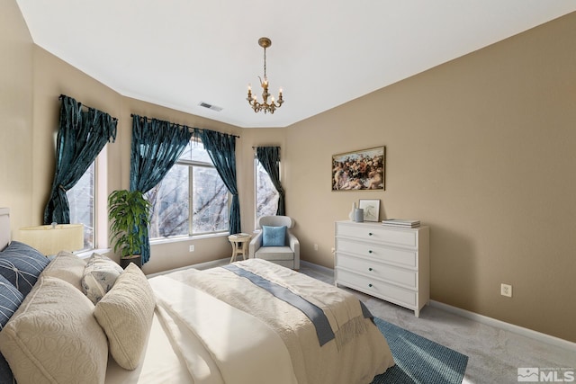 bedroom featuring light colored carpet and a chandelier