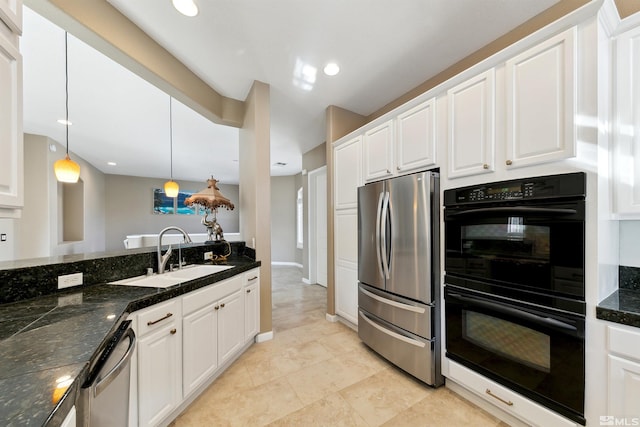 kitchen featuring stainless steel appliances, white cabinetry, sink, and decorative light fixtures