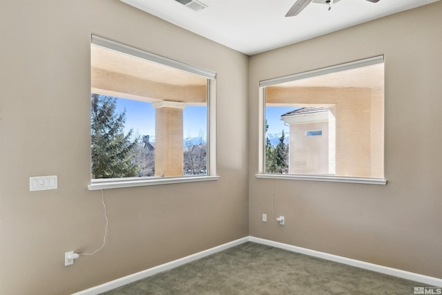 spare room featuring carpet floors and ceiling fan