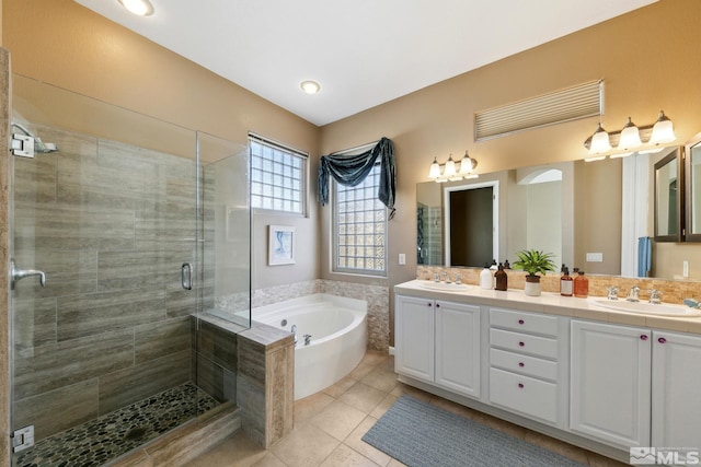 bathroom with vanity, shower with separate bathtub, and tile patterned flooring