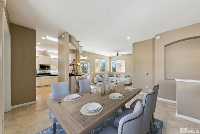 tiled dining area featuring ceiling fan