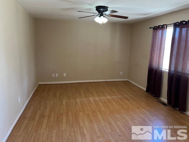 empty room featuring ceiling fan and light hardwood / wood-style floors