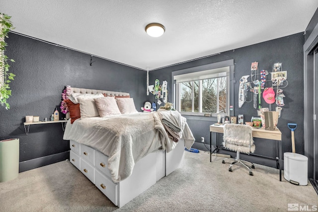 carpeted bedroom with a textured ceiling