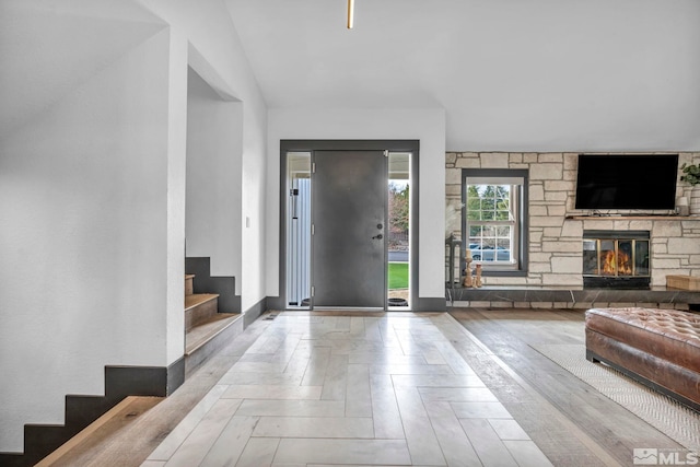 entryway featuring light parquet floors and a fireplace