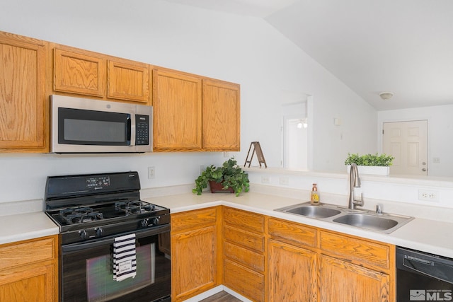 kitchen with lofted ceiling, sink, and black appliances