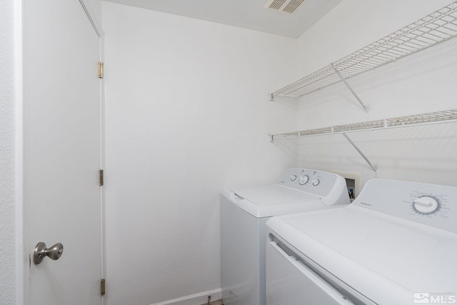 clothes washing area featuring washing machine and clothes dryer