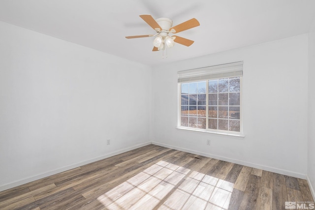 empty room with hardwood / wood-style flooring and ceiling fan