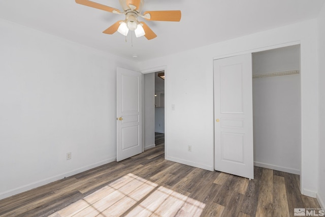 unfurnished bedroom featuring a closet, dark hardwood / wood-style floors, and ceiling fan